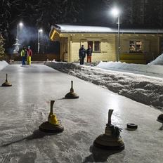 Funny curling game on the natural ice rink